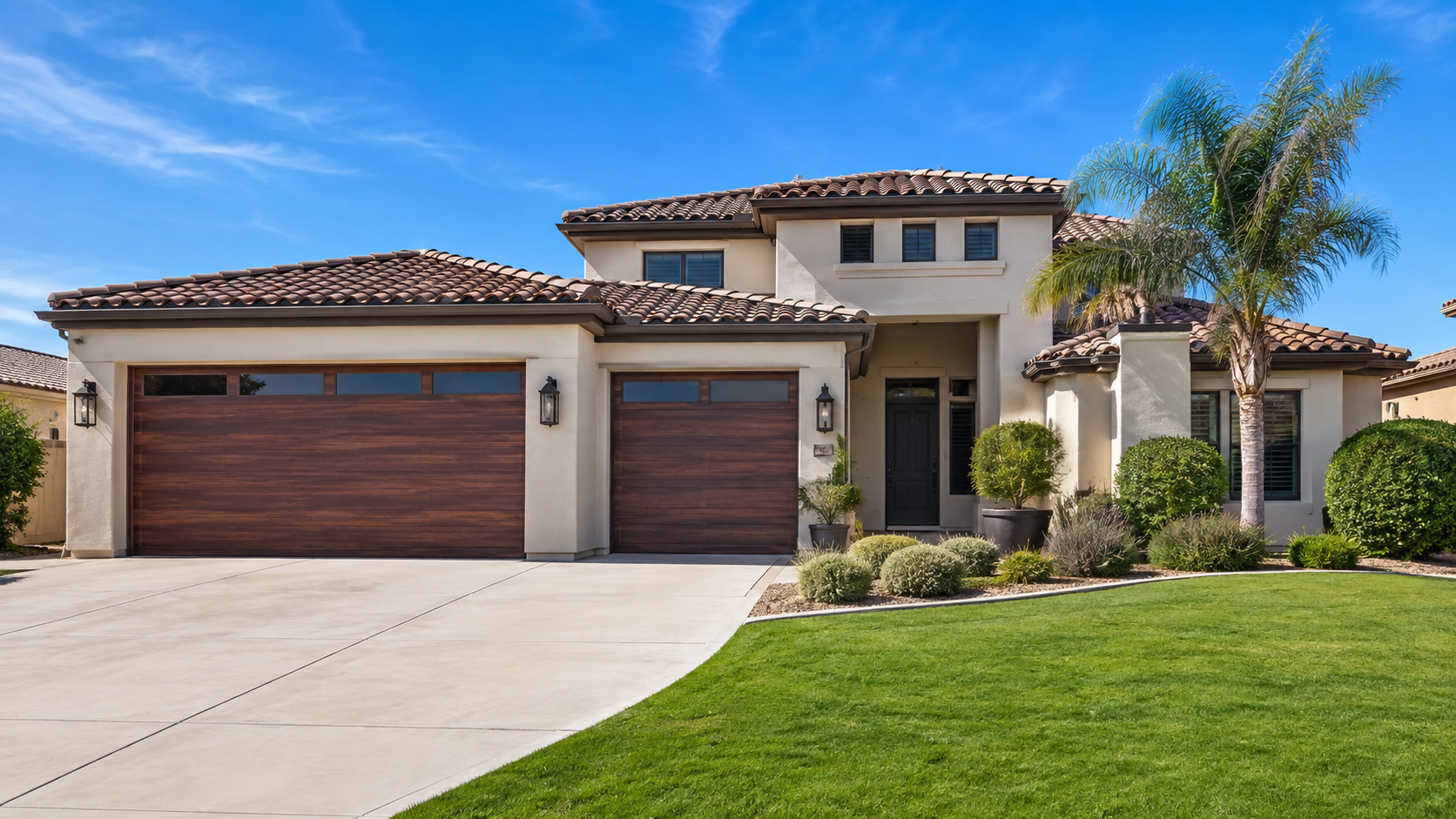 Arizona stucco home with a modern wood-look steel garage door